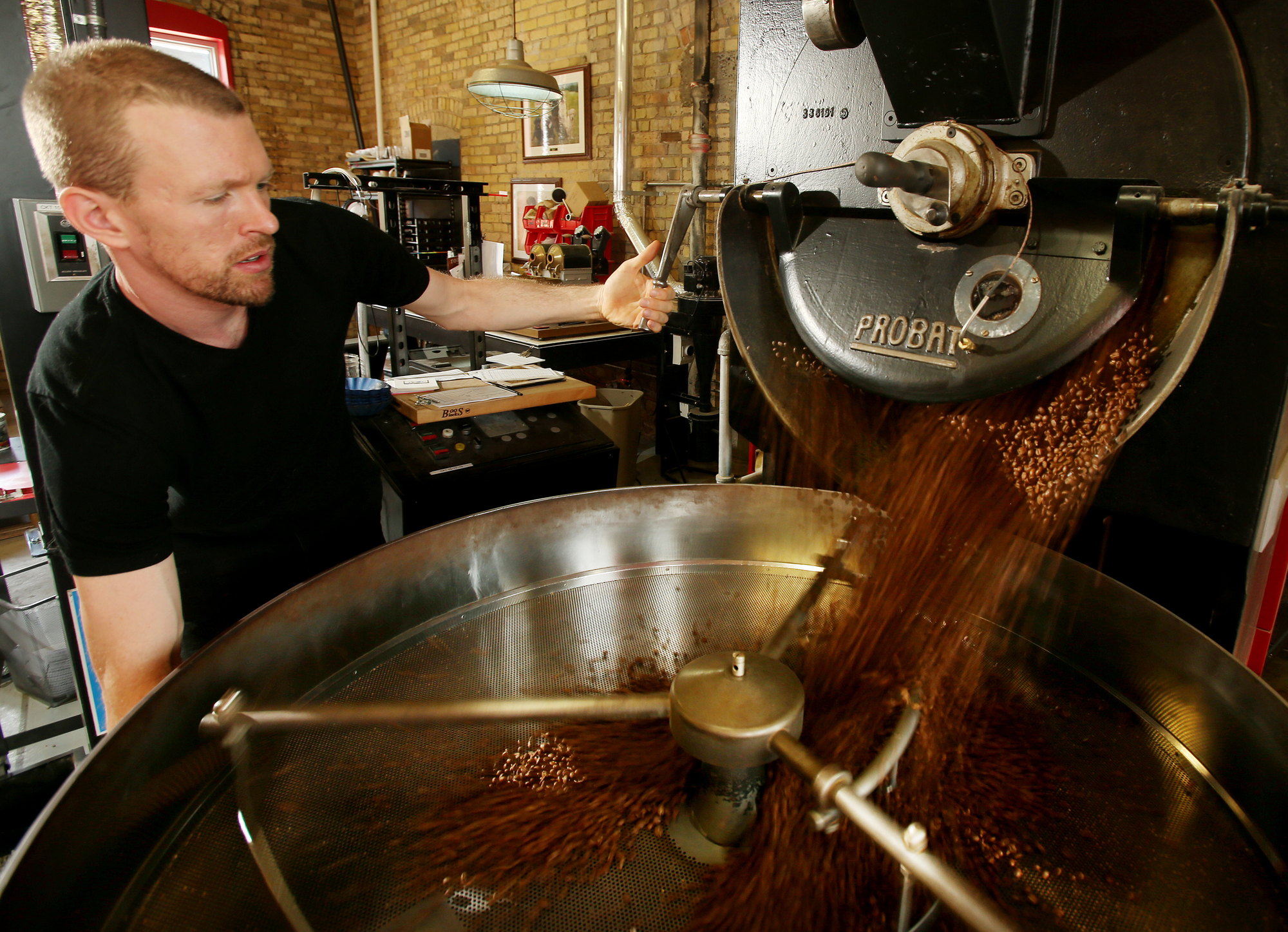 employee roasting coffee beans